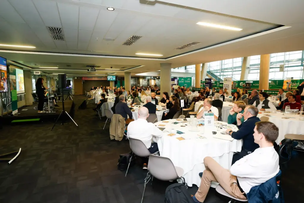 Image of CEO Donna Gartland speaking to a full room of attendees in the 1872 area of the Aviva Stadium.