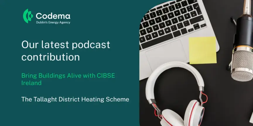 Image of a laptop, sticky notes, mic and headphones on a desk.